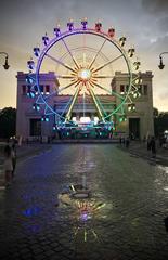 Propylaea at Königsplatz in Munich with an illuminated ferris wheel at night