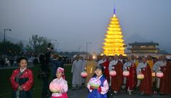 Monks and believers circle a stone pagoda-shaped lantern during the Lotus Lantern Festival in Gwanghwamun Square, Seoul.