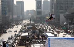 Snowboarder Zebastian Landmark performing a big air trick in Seoul