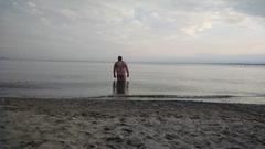 Person walking into Lake Ontario at Hanlan's Point Beach