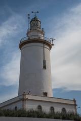 La Farola lighthouse in Málaga under a clear blue sky