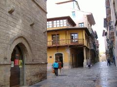 narrow street Calle Ferreria in Tarragona with historical buildings and balconies