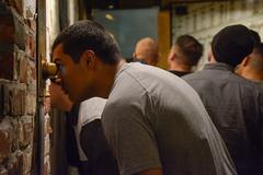 A soldier from Battle Group Poland observing photographs at the Uprising Museum in Warsaw