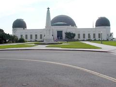 Griffith Observatory at night with city lights in the background