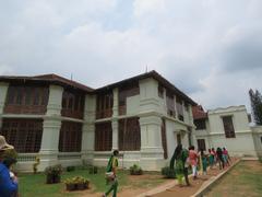 Scenic view of a lush garden with trees and a pathway at Hill Palace in Tripunithura