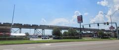 Clearview Parkway in Elmwood, Louisiana with a freight train on a rail ramp leading to the Huey P. Long Bridge in the background