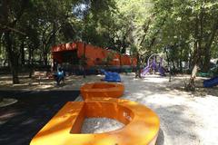 Parque España in Mexico City with lush green vegetation and people enjoying leisure activities