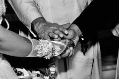 Hindu priest blessing bride and groom during wedding ceremony