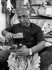 woodworker adding finishing touches to a wood sculpture