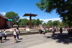 a giraffe standing in a grassy enclosure at Denver Zoo