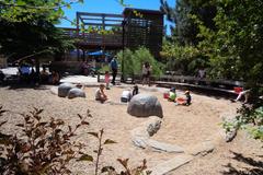 Denver Zoo entrance with visitors and lush greenery