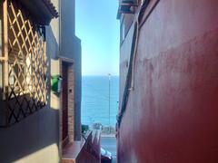 A panoramic view of Ceuta with buildings and mountains in the background