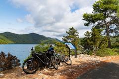 Cyclists on a scenic lakeside tour in Mljet, Croatia