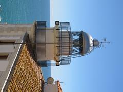 Far de Peníscola lighthouse on c. Castell 12 street under a clear blue sky