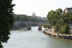 Bridge to Trastevere over Tiber River with St. Peter's Basilica in background, Rome, Italy