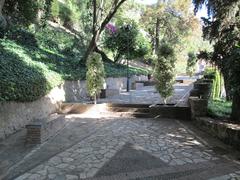 Jardines de Puerta Oscura with lush greenery and walking paths in Málaga, Spain