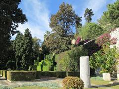 Jardines de Puerta Oscura with a historical column in the foreground