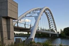 modern steel arch footbridge over Humber River in Toronto