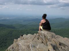 woman sitting on Humpback Rock overlooking Shenandoah Valley