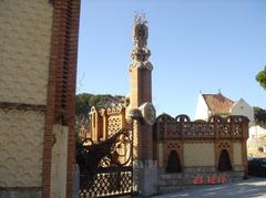 Güell Pavilion with chimneys and decorative ironwork under a blue sky