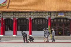 Ceremony personnel setting up a red carpet during the 107th Republic of China Memorial Day