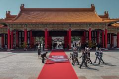 ceremonial staff laying a red carpet for a national memorial event in Taiwan