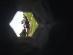 View of ancient site through a stone window hole