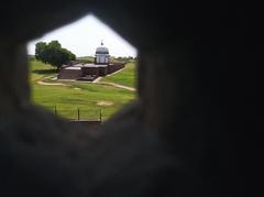 view of site through window hole from the terrace of Raja Harsh ka Tila tomb