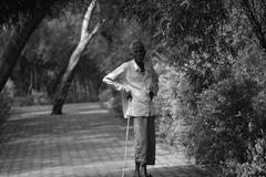 an old man walking with a stick in Indroda Park, Gujarat