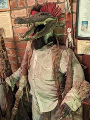 Swamp zombie display at New Orleans Voodoo Museum with an alligator head