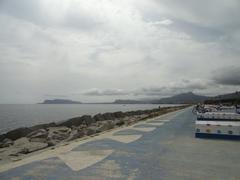 People jogging and cycling on seaside boardwalk in Palermo, Sicily