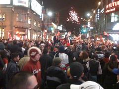 Hockey fans celebrating Canada's gold medal at Dundas Square