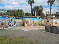 Colorful murals by Lalo Luque (Lalone) on a public restroom and service module at Misericordia Beach in Malaga, Spain