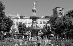 Plaza Bib-Rambla in Granada, Spain, with people walking and historic buildings