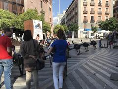 Marta Higueras riding a bicycle during the World Refugee Day event organized by Accem