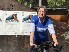 Marta Higueras riding a bicycle during the World Refugee Day event organized by Accem