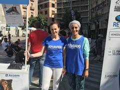 Marta Higueras riding a bicycle during World Refugee Day event organized by Accem