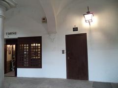 Traditional pastry shop on the left and cathedral chapter house gate on the right