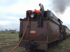 Water carriage being filled for a steam train journey