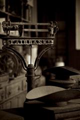 sepia-toned image of a Chihuahua balancing on a scale