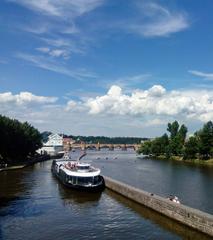 Ships on Vltava River near Charles Bridge at sunset