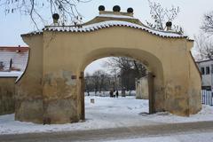 Kampa Park in winter with snow-covered trees and buildings