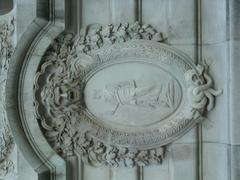 Cartouche of d'escutcheon at the staircase entrance of Palais de la Découverte in Paris