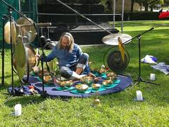 Player with Tibetan singing bowls and gongs