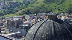 A panoramic view of Aparecida, SP featuring its famous basilica and surrounding buildings under a bright blue sky