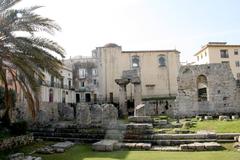 Ruins of the Temple of Apollo in Syracuse, Italy, viewed from Ortigia market