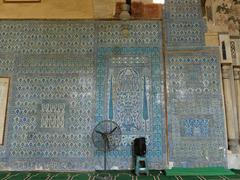 Aqsunqur Mosque interior view featuring Iznik tiles on the qibla wall