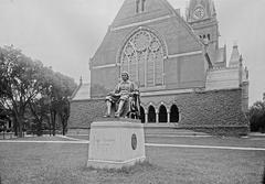 John Harvard statue at its original site west of Memorial Hall