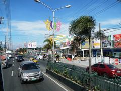 road passing through a rural area with greenery and mountains in Nasugbu, Batangas, Philippines