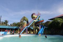 Blumen Resort pool with clear blue water and surrounding palm trees